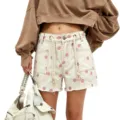 Women's polka dot denim shorts with chic braided drawstring and eyelet details, casual fit. - S / Pink