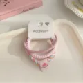 Detail shot of a 3-piece braided hair tie set in pink tones with a cute watermelon charm. - 3 Pieces/Pack / Pink