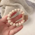 Cute bunny hair tie for women, high elasticity plush ball hair rope with leather label decoration. - Beige