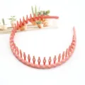 Close-up detail of coral pink plastic wavy hairband with anti-slip teeth, stylish hair accessory. - F-016 Wave Style / 1 Piece / Pink