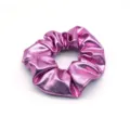 Close-up detail shot of the shiny metallic pink hair scrunchie, showing fine texture. - Light Red