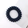 Close-up detail shot of a dark blue telephone wire hair tie showing texture and high elasticity. - Navy Blue