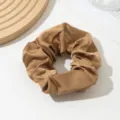 Detailed close-up of a smooth brown satin hair scrunchie, elegant and soft texture accessory. - Light Coffee