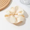 Close-up detail of a soft beige satin hair scrunchie showing smooth fabric texture. - Off White