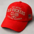 Red embroidered baseball cap with novelty slogan text and side flag patch for casual wear. - Red