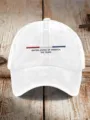 White distressed cotton baseball cap with embroidered US flag stripe and patriotic lettering. - White
