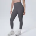 Detailed view of high-waisted solid color yoga leggings showing soft fabric and fit. - S / Bottoms / Graphite Gray (7140)