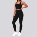 Detailed shot of a solid black seamless sports bra and high-waisted yoga leggings set. - S / Top And Bottom / Black