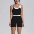 Close-up detail of women contrast color fitness sports vest and shorts workout set. - S / Top And Bottom / Premium Black