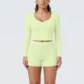 Detailed close-up of light green long-sleeve crop top and shorts yoga activewear set. - Lemon Green