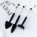 Mini gardening tool set for succulent potted plants, including small shovels and rake. - Black