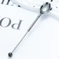 Stainless steel long-handled coffee spoon dessert spoon with twisted handle and ball end. - Plated Gunmetal