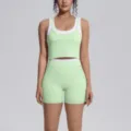 Close-up detail of light green and white two-piece yoga set, activewear fitness top and shorts. - Mint Green