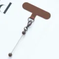 Brown mobile phone tether tab with metal charm strap connector variant accessory. - Coffee