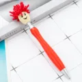 Red plush doll head ballpoint pen with funny design, smooth writing for office and school use. - Red