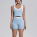 Stylish two-piece athletic yoga set featuring a blue layered tank top and matching shorts. - Mist Blue
