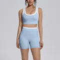 Detail shot of light blue colorblocked yoga set, nylon nude fabric, sports bra & shorts. - Mist Blue