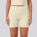 High-waisted tight yoga shorts detail shot, breathable nude feel activewear for fitness. - S / Light Ivory