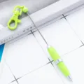 Portable mini keychain retractable pen, creative green gift pen with keyring for daily use and decor. - Macaron Green