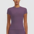 Close-up detail of women's purple short sleeve sports top showing slim fit and fabric. - S / Top (7156 Short Sleeve) / Purple Thistle
