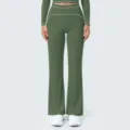Detail view of high waist olive green flared yoga pants featuring elegant white contrast piping. - Smoke Moss Green