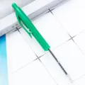 Green retractable plastic ballpoint pen with transparent barrel and visible ink refill for office. - Dark Green