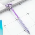 Purple crystal bow ballpoint pen with sparkling rhinestones inside clear barrel for gift writing. - Purple