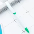 White plastic ballpoint pen with green clip and tip for office and school stationery use - White Barrel - Green