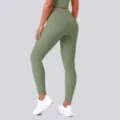 Detail view of high-waisted seamless yoga leggings in green, designed for fitness and running. - S / Bottoms / Cedar Green