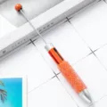 Oranger multifunktionaler 4-in-1 Kugelschreiber mit glitzerndem Kristallgriff und Teleskopspitze. - Orange