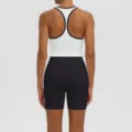 Detailed view of the athletic sports bra and tight yoga shorts, showcasing fine stitching. - S / Top And Bottom / White Body Black Edge Tank + Black Shorts
