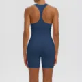 Detail view of solid blue racerback yoga sports bra and biker shorts set, breathable fitness apparel. - S / Top And Bottom / Navy Blue
