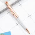 Elegant rose gold metal ballpoint pen with crystal filled lower body and cute crown top. - Rose Gold