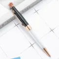 Luxury crystal crown ballpoint pen with rose gold accents and glittering diamonds in barrel. - Black & Rose