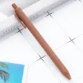 Brown retractable ballpoint pen with matte spray finish, smooth writing student stationery variant. - Coffee