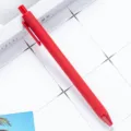 Matte red retractable ballpoint pen, smooth writing plastic stationery for school and office. - Red