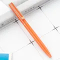 Stylo à bille métallique orange avec clip or rose et mécanisme rotatif pour le bureau. - Orange