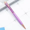 Purple glitter ballpoint pen with rose gold accents and floral clip for daily writing. - Violet