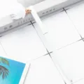 White metal ballpoint pen featuring a delicate fabric flower charm, perfect for daily stationery use. - White
