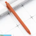 Orange retractable ballpoint pen with smooth rubber finish for student stationery and office use. - Orange Red
