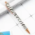 Retractable metal ballpoint pen with stylish zebra print pattern and rose gold accents for office. - White Zebra Print