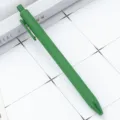 Green retractable ballpoint pen, matte rubberized finish, smooth writing student stationery supply. - Grass Green