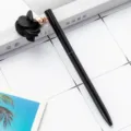Sleek black metal ballpoint pen featuring an elegant black fabric flower pendant charm variant. - Black
