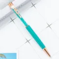 Turquoise crystal ballpoint pen with rose gold metal finish and floral clover clip detail. - Peacock Blue