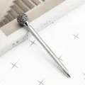 Elegant silver metal ballpoint pen with sparkling rhinestone sphere top, smooth twist writing. - Electroplated Silver