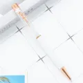 Elegant rose gold crystal ballpoint pen with floral clip, white barrel and sparkling stones. - White