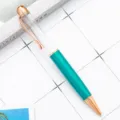 Teal metal ballpoint pen with rose gold trim and clear upper barrel for custom promotion. - Peacock Blue (Rose Gold Accents)