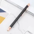 Black metal retractable ballpoint pen with elegant rose gold trim for business and office. - Black
