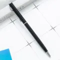 Sleek black metal ballpoint pen with silver trim, professional business gift and office supply. - Black