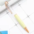 Pastel yellow metal ballpoint pen with elegant rose gold trim and clear cap design variant. - Yellow (Rose Gold Accents)